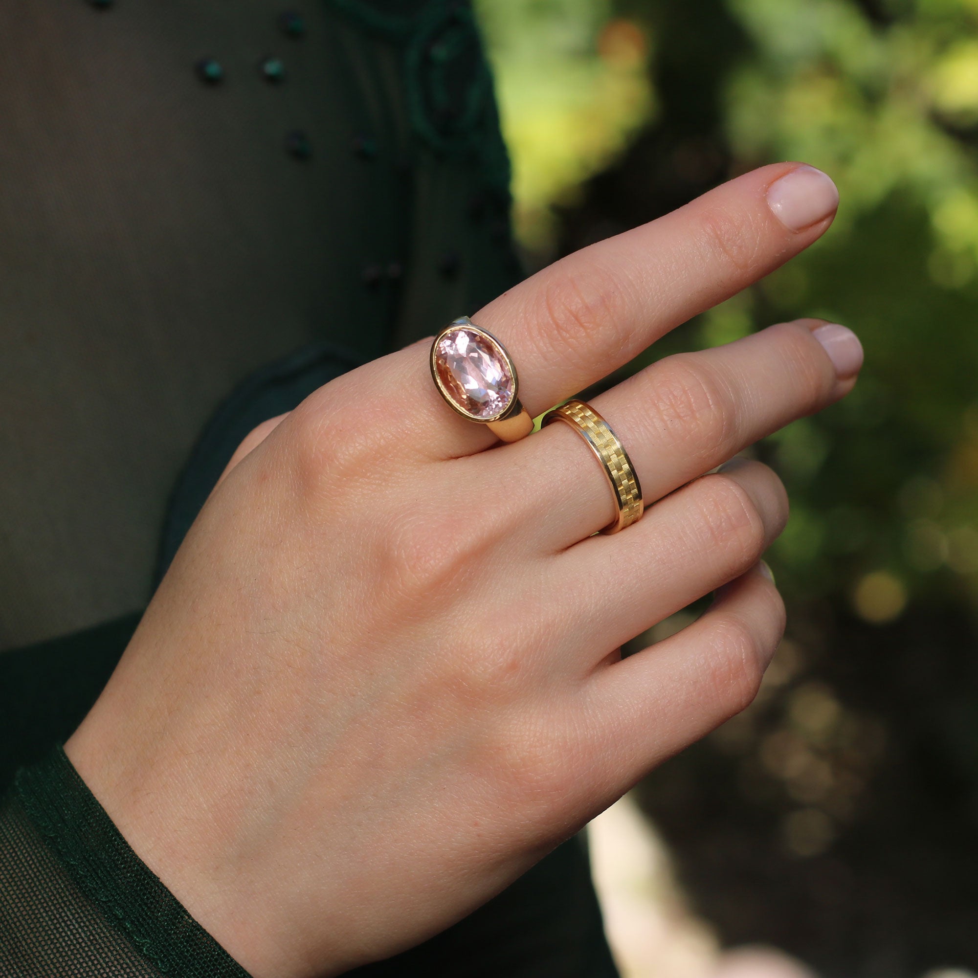 Model wearing 18k gold rings,  kunzite ring with basket weave engraved setting and basket weave band ring from Los Angeles jewelry designer Brooke Gregson