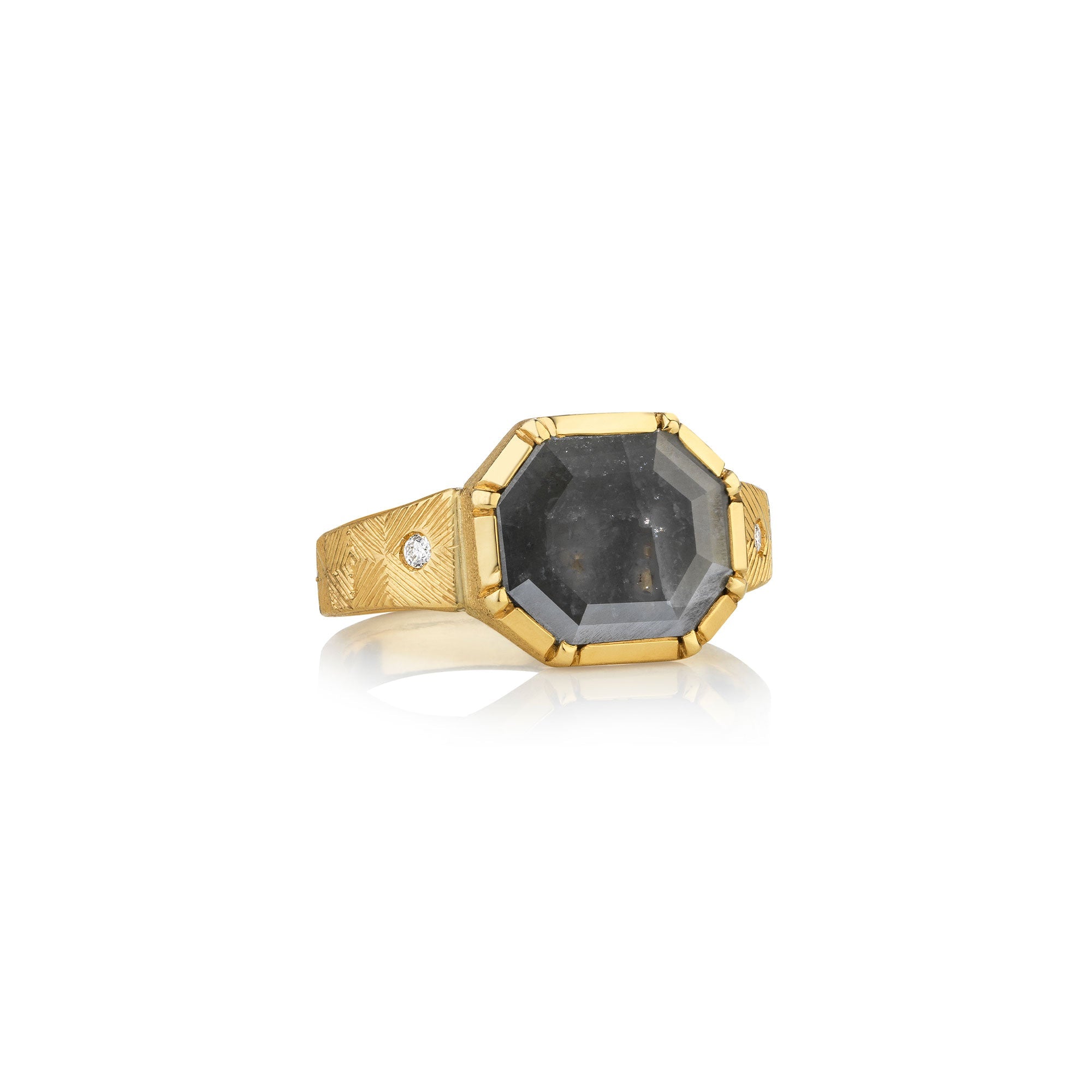 Gold ring with a large raw diamond gemstone on a white background