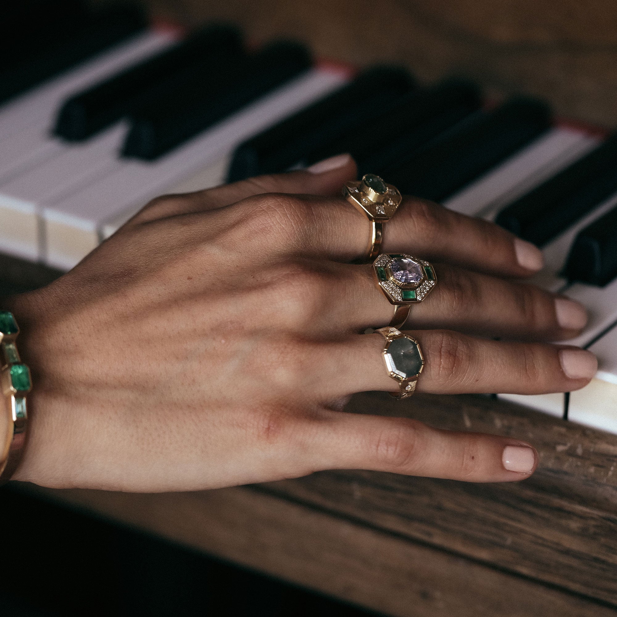 Hand with multiple rings on a piano keyboard