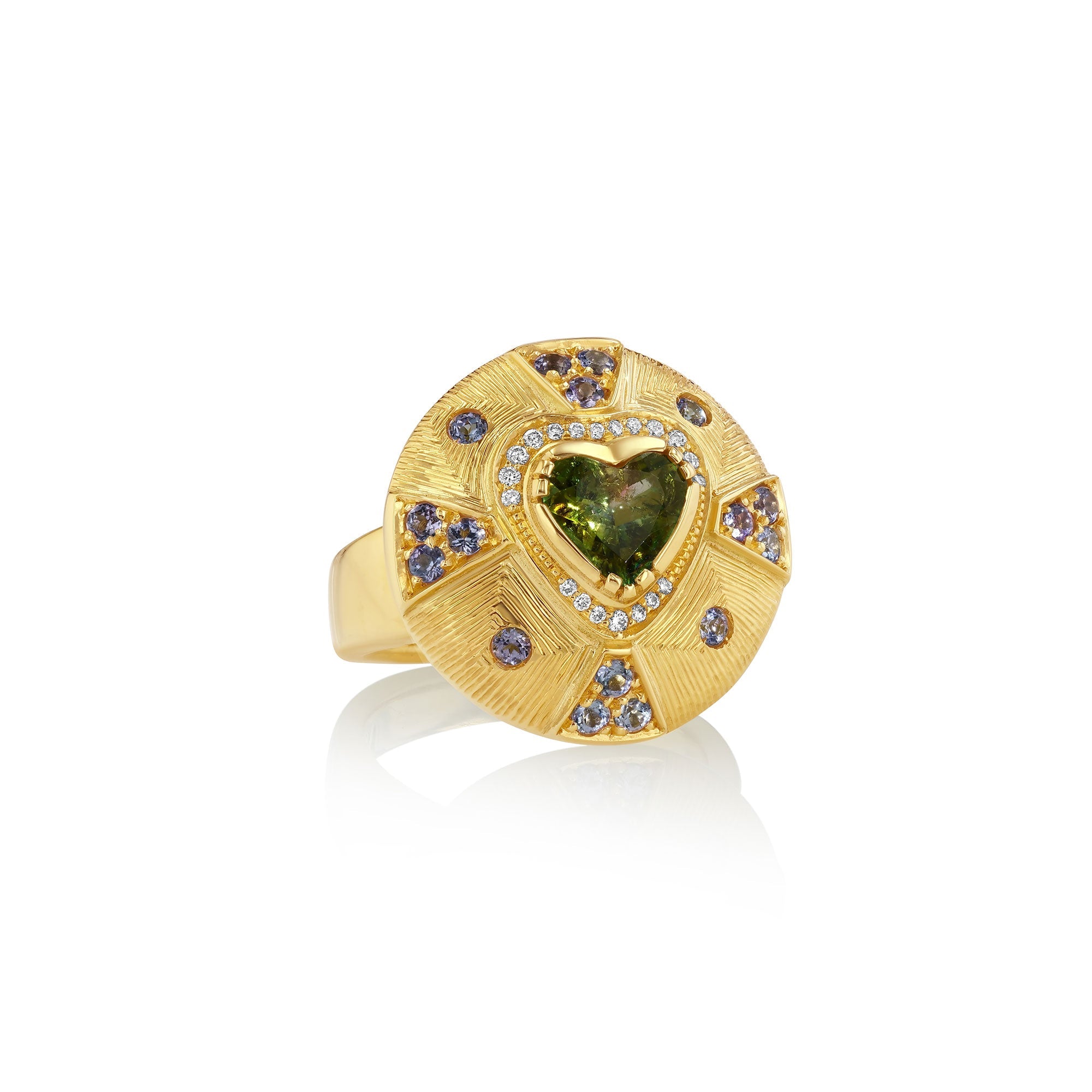 Gold ring with a heart-shaped green tourmaline gemstone and tanzanite rays on a white background