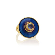 Gold ring with a blue sapphire stone and garnet gemstones with blue enamel work on a white background