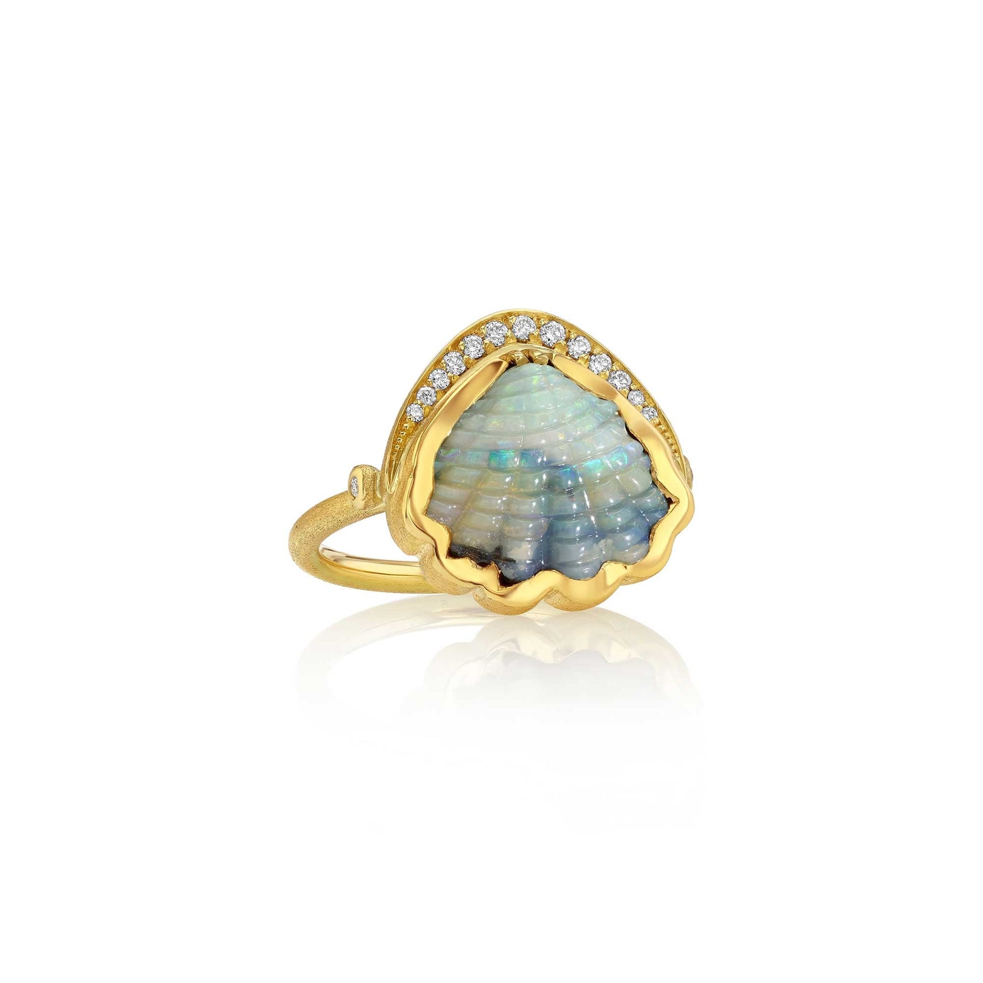 A gold ring featuring a scalloped opal shell centerpiece with iridescent blue and green hues, accented by a row of small diamond stones along the top, set against a clean white background with a soft reflection.