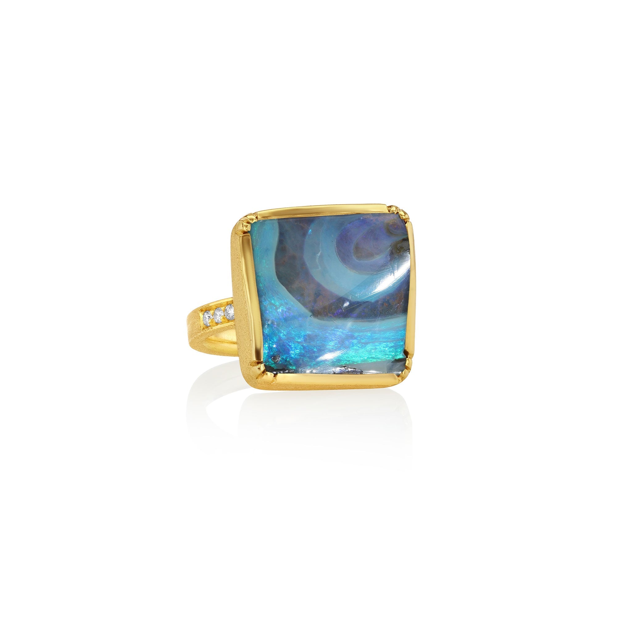 Front shot of gold ring with a boulder opal blue gemstone on a white background.