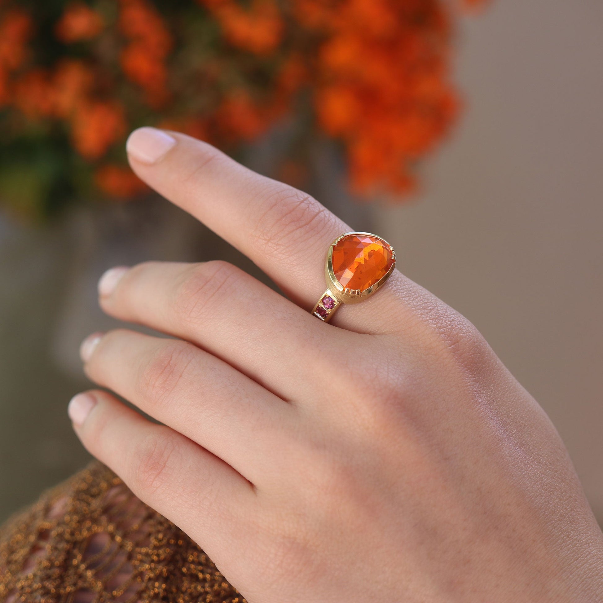 Model wearing one of a kind Fire Opal ring with Ruby band from Los Angeles designer Brooke Gregson fine jewelry handmade in London