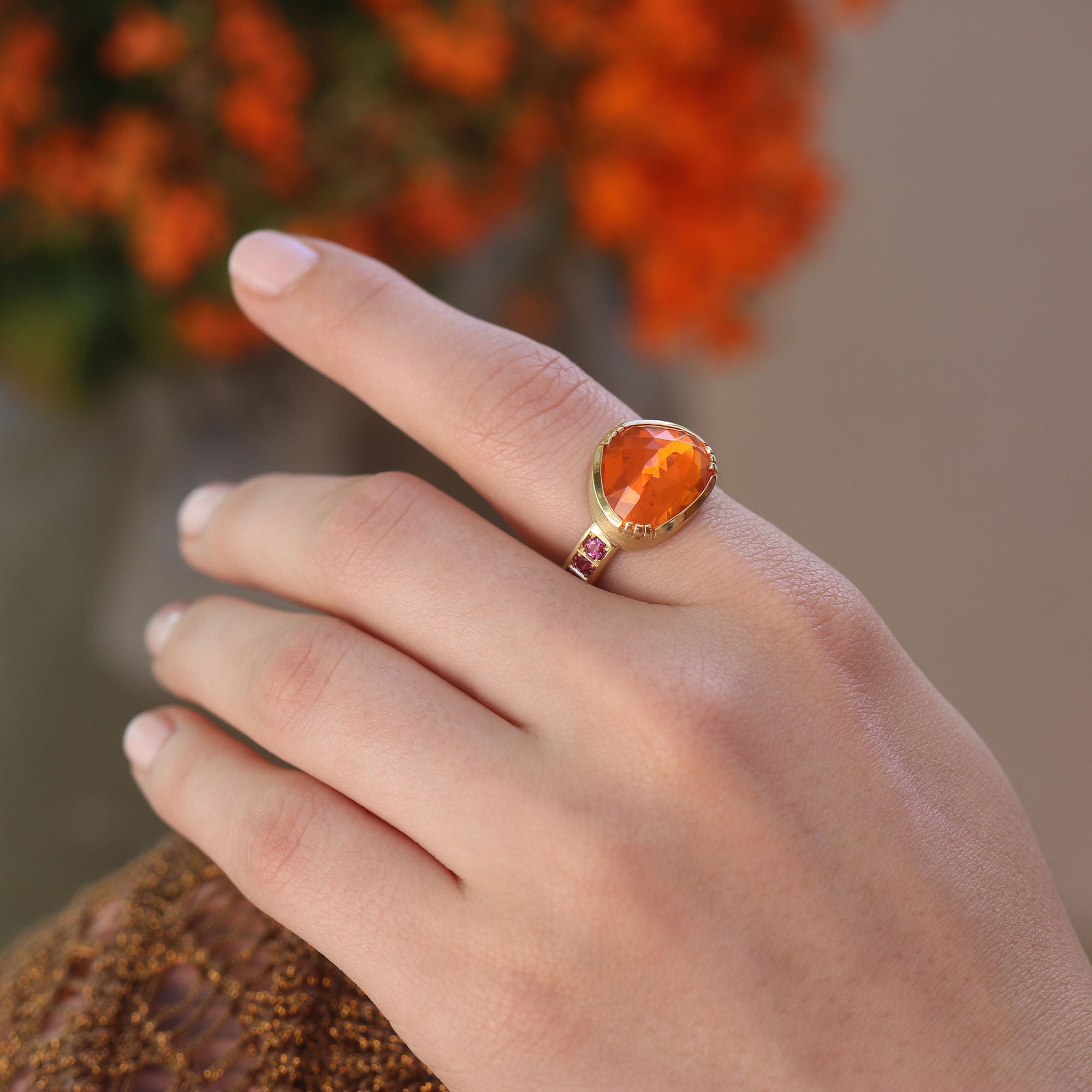 Model wearing one of a kind Fire Opal ring with Ruby band from Los Angeles designer Brooke Gregson fine jewelry handmade in London