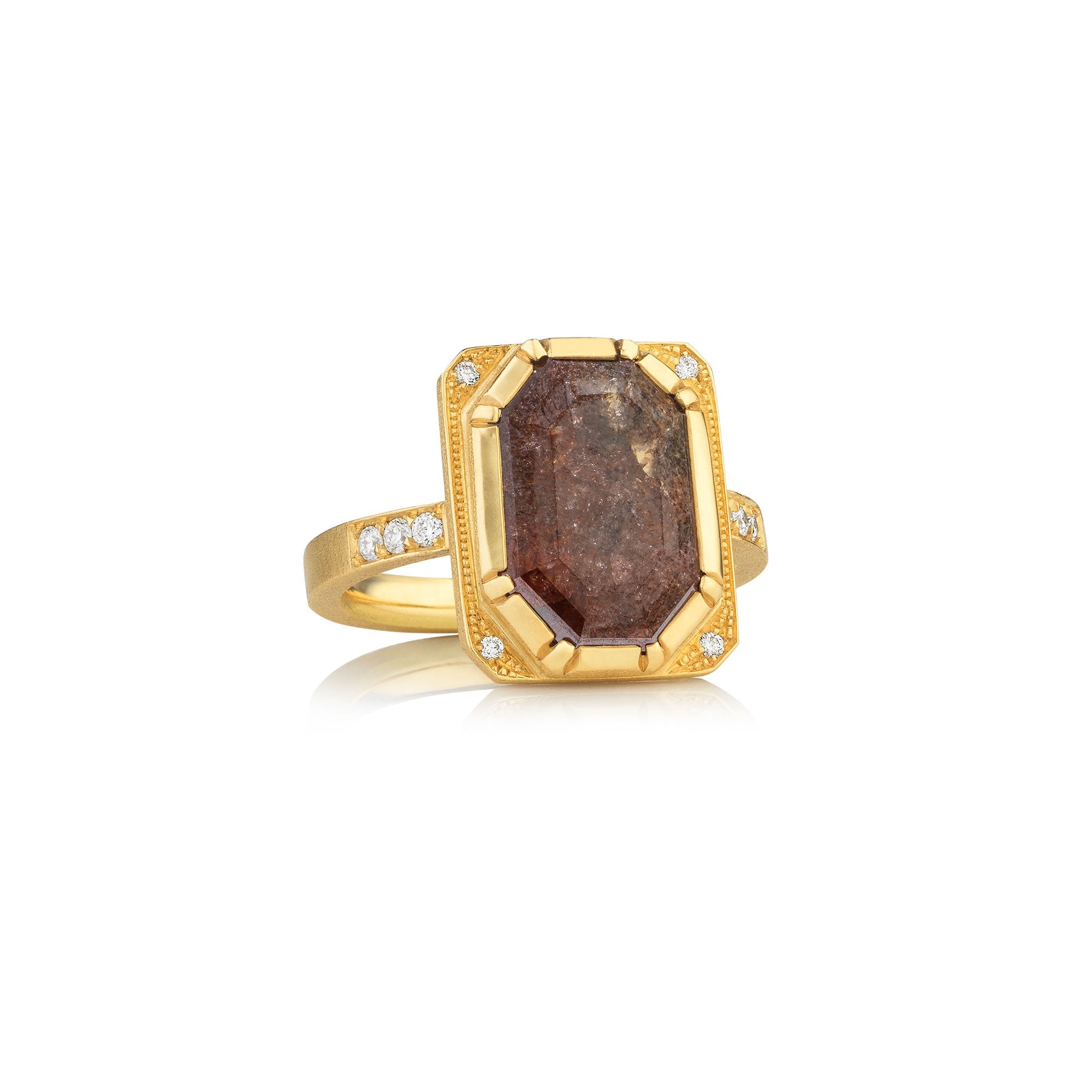 Gold ring with a large raw diamond brown stone and smaller stones on a white background