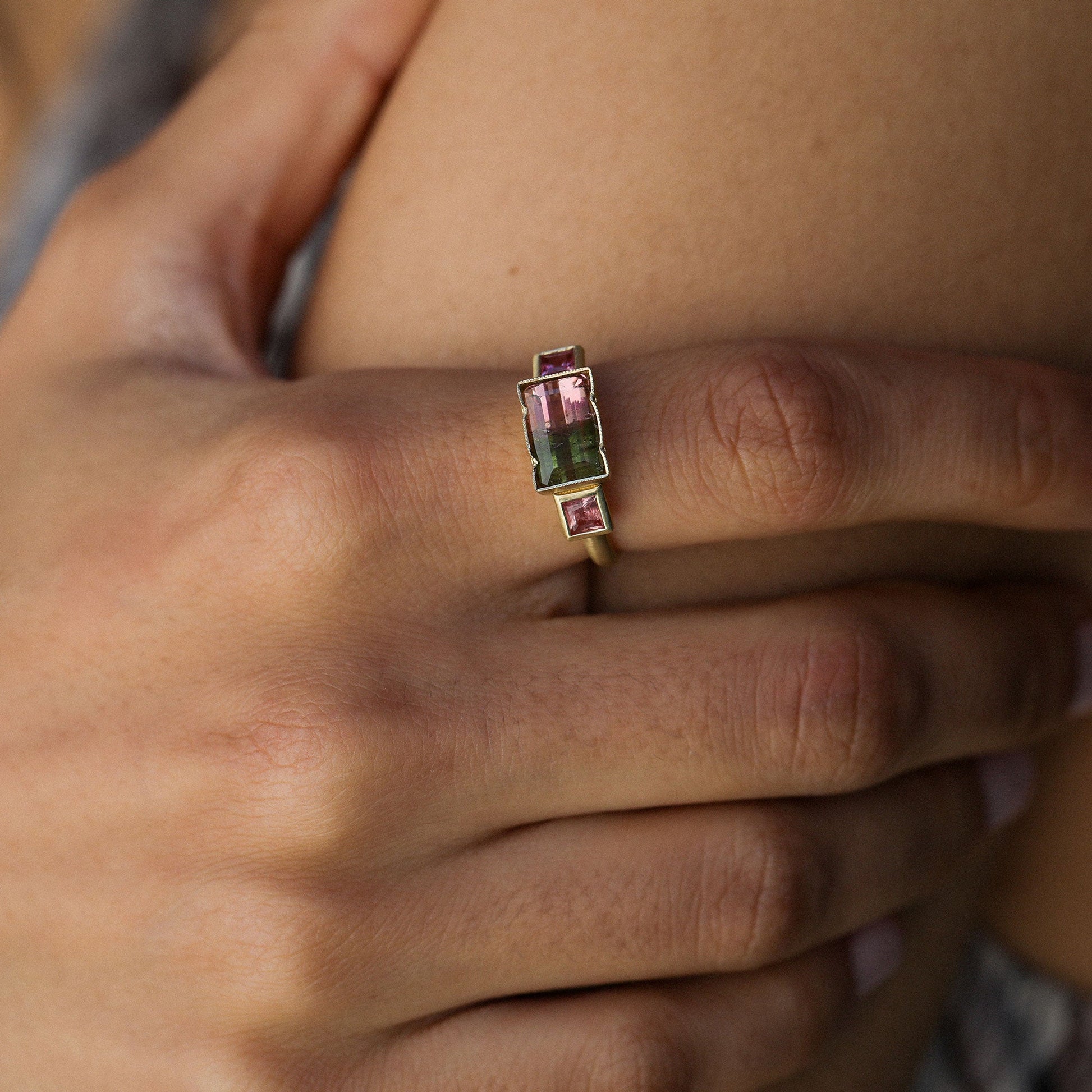 close up of a girl wearing a bicolour tourmaline ring designed by brooke gregson