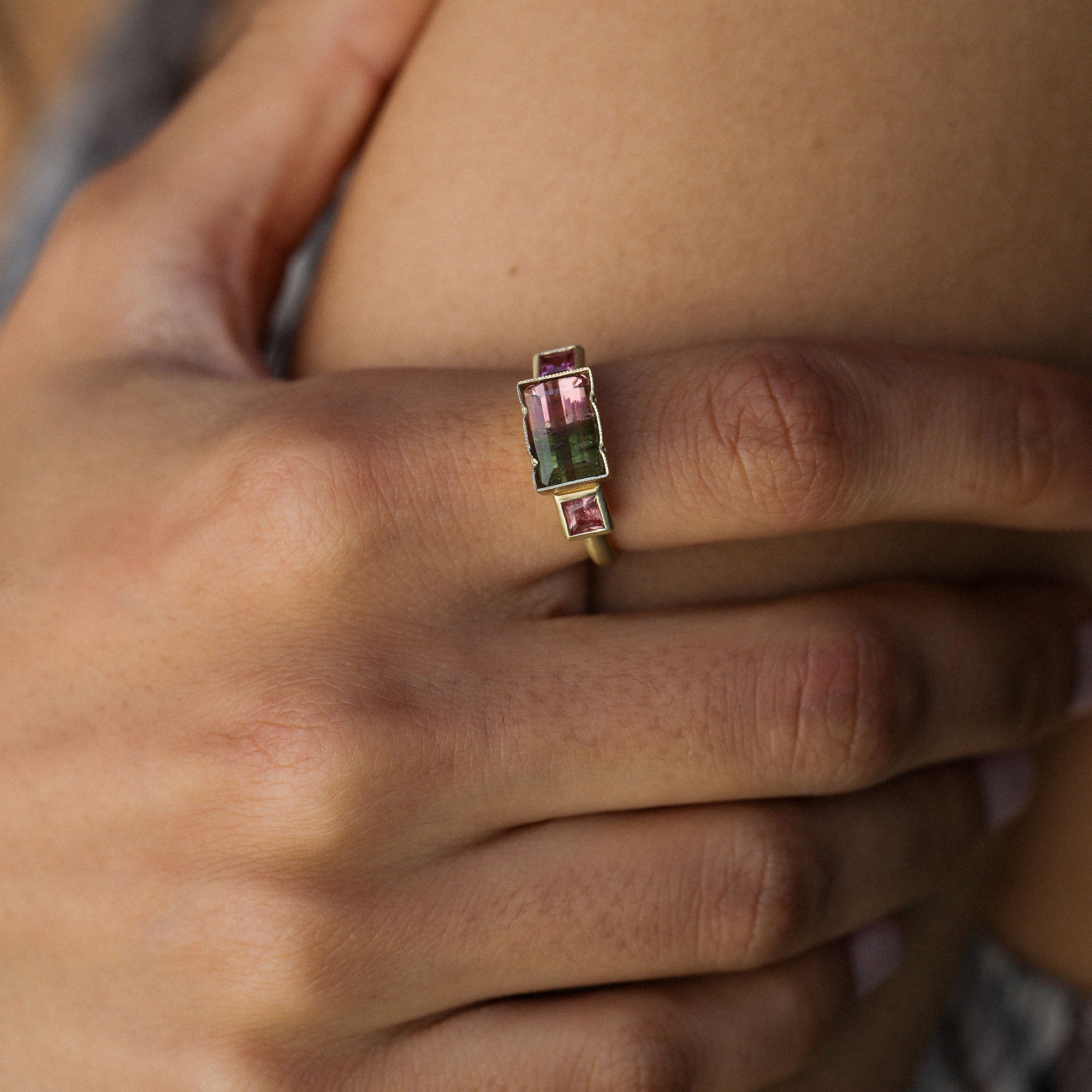 close up of a girl wearing a bicolour tourmaline ring designed by brooke gregson