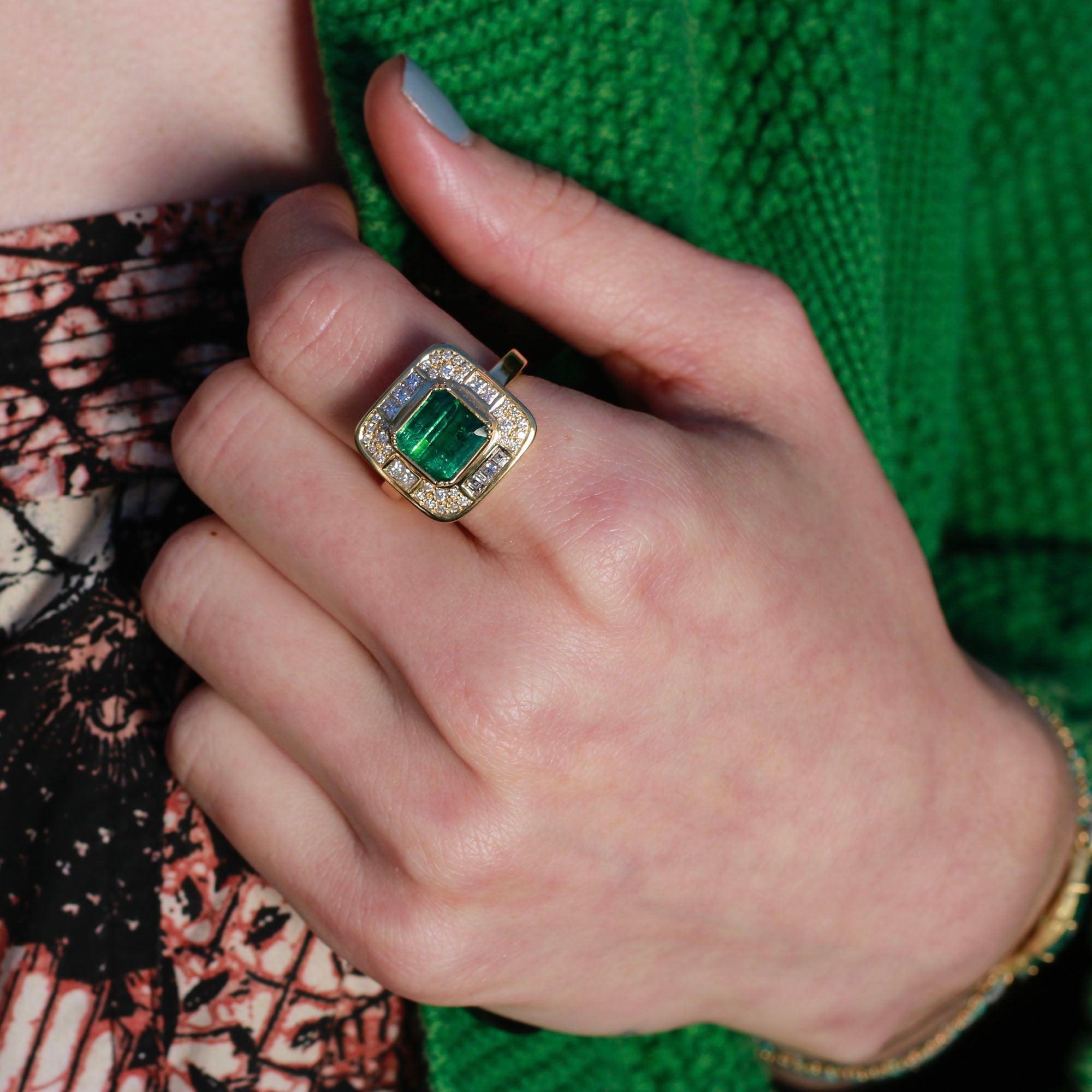 Model wearing Emerald ring and diamond accent from Los Angeles designer Brooke Gregson fine jewelry handmade in London.