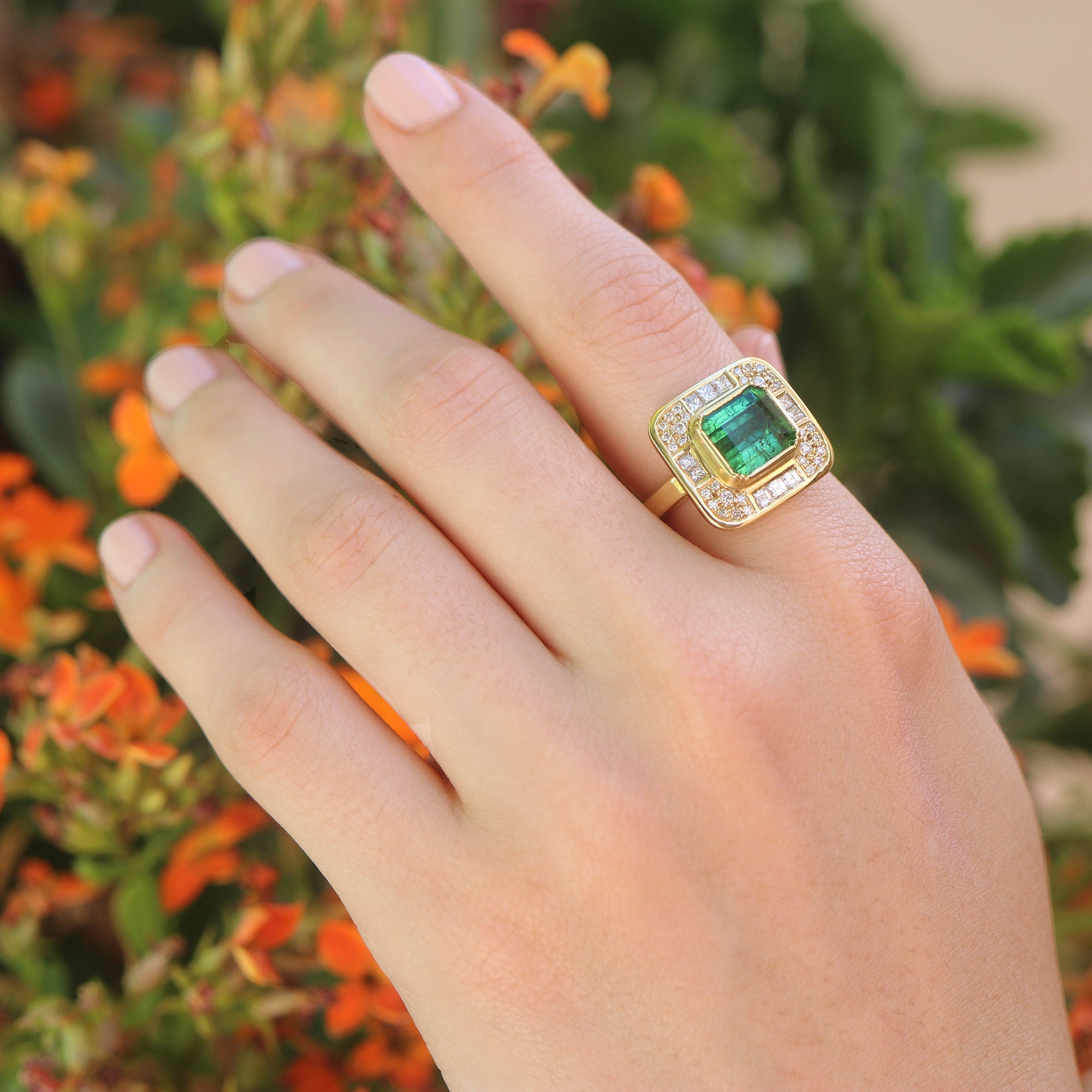 Model wearing Emerald ring with diamond accent from Los Angeles designer Brooke Gregson fine jewelry handmade in London.