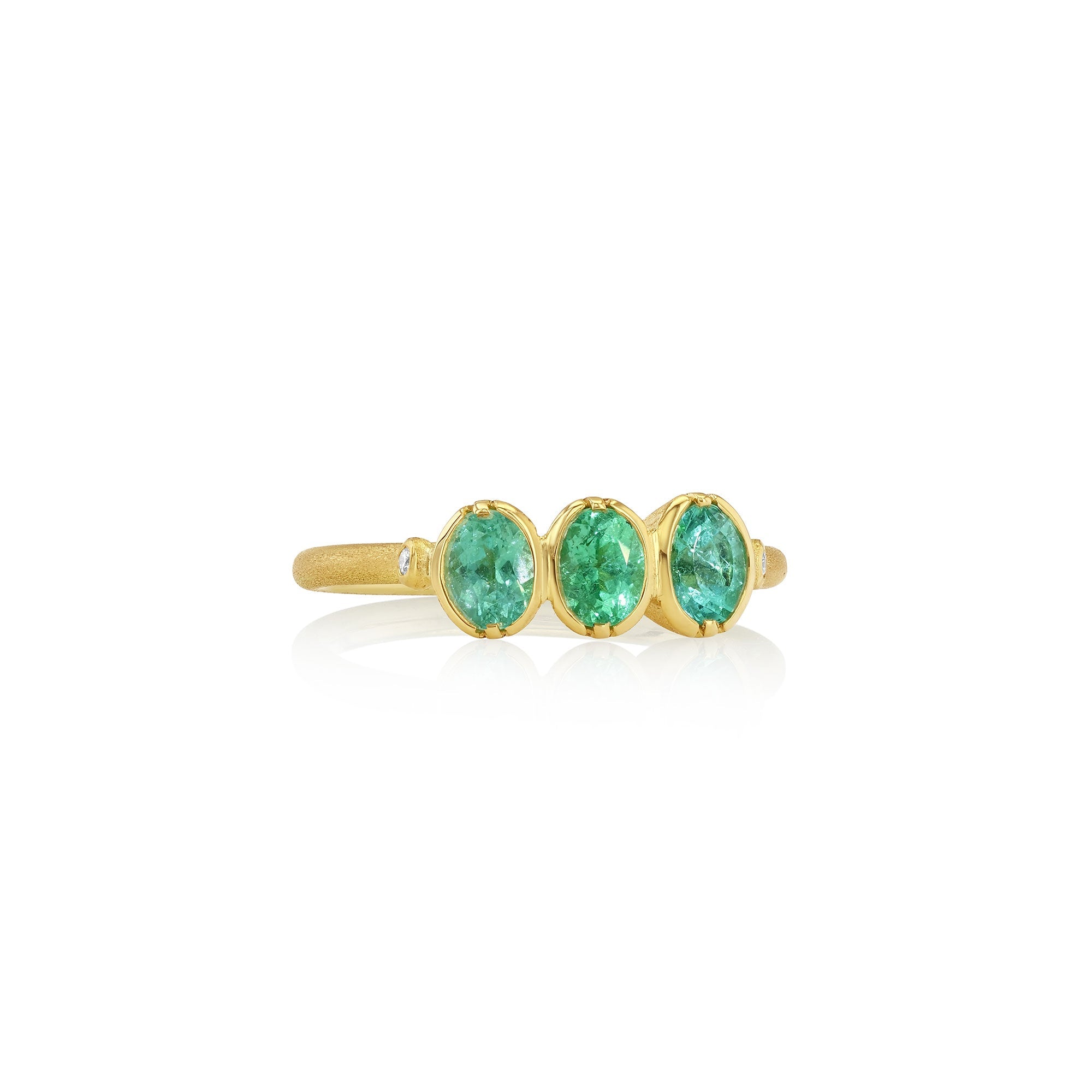 Gold ring with three green paraiba tourmaline gemstones on a white background