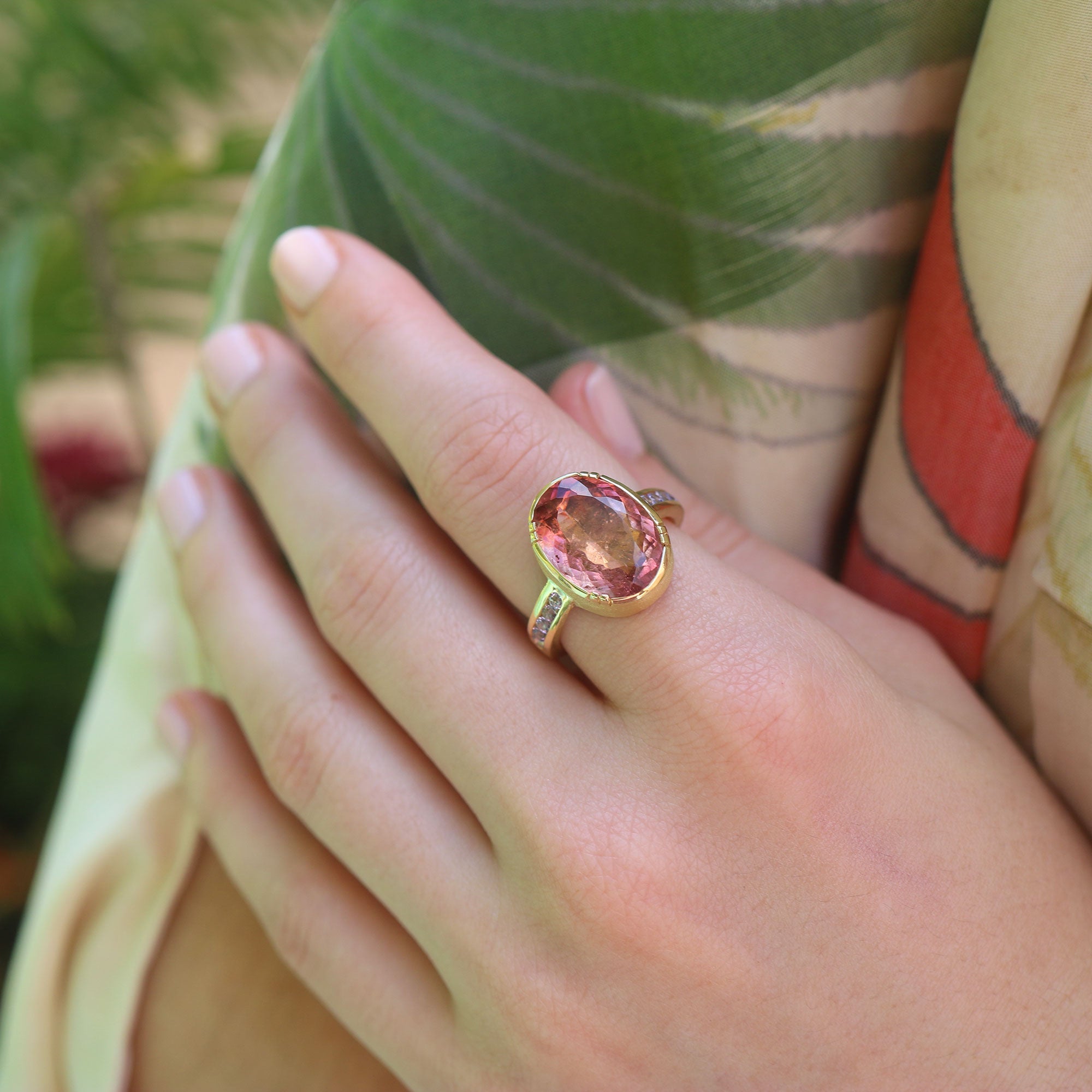 Model wearing one of a kind Orange Pink Tourmaline Ring with Tanzanite pave band from fine jewelry designer Brooke Gregson handmade in London