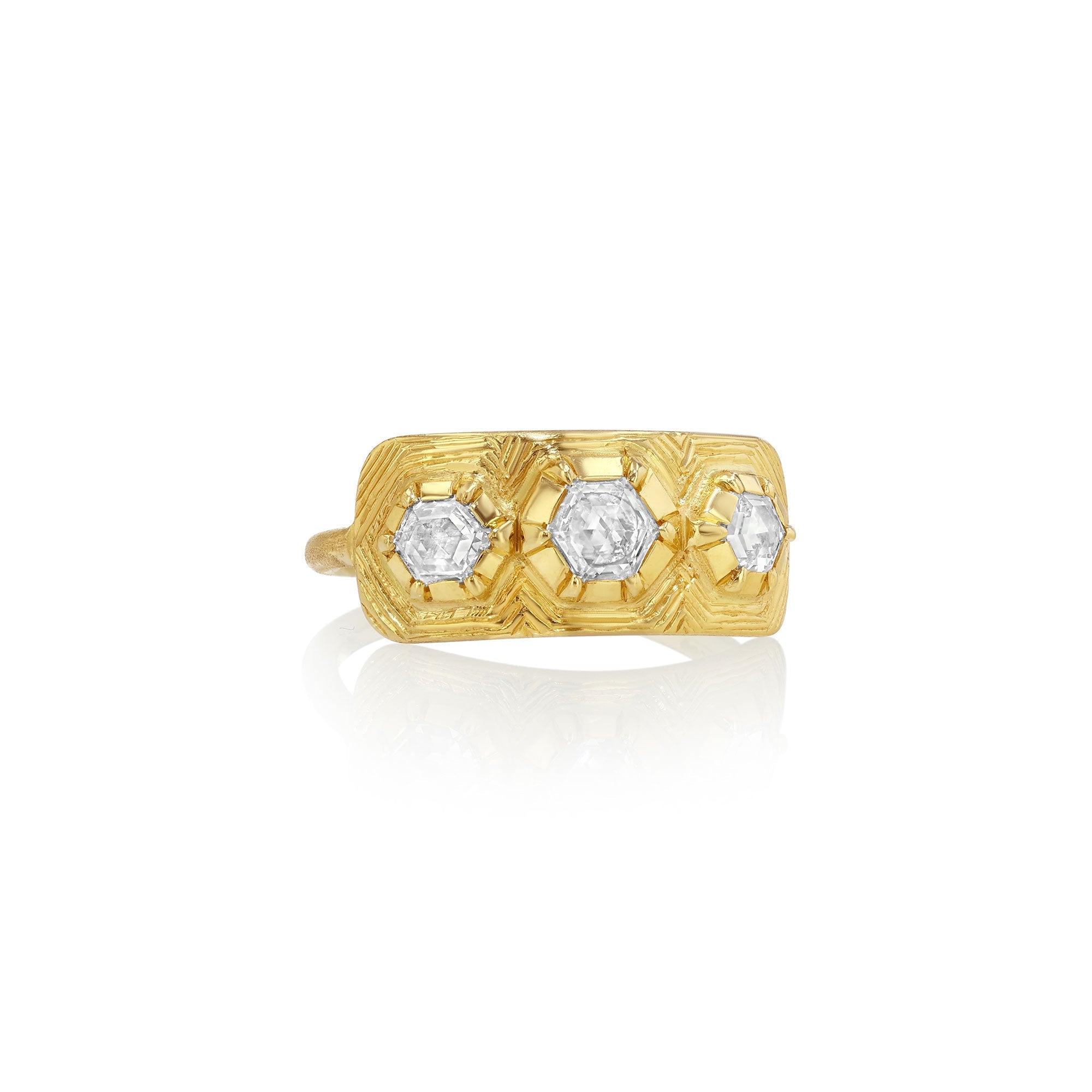 Gold ring with three hexagonal diamond stones on a white background